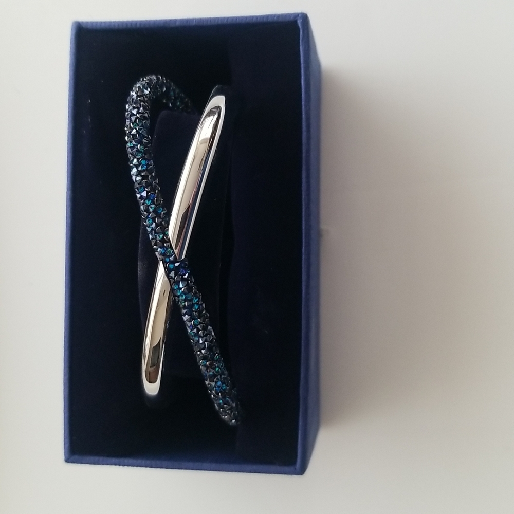Swarovski crystaldust cross cuff with blue crystals. Box included.